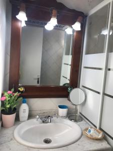 a bathroom with a sink and a mirror at Apartamento Rural situado en tercera planta sin ascensor in Navás