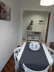 a dining room with a black and white table and chairs at El balcón de Padrón in Padrón