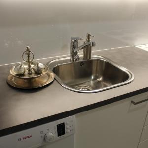 a kitchen counter with a stainless steel sink at Bright star apartament Siilinjärvi in Siilinjärvi