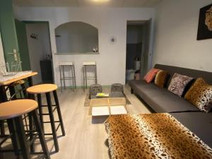 a living room with a couch and some bar stools at La Cigale in Annot +24 photos