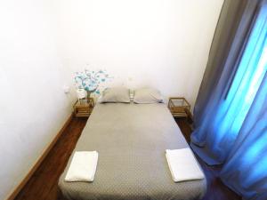 uma cama num quarto com cortinas azuis em Aveiro Guest House em Aveiro