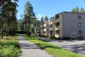 a row of apartment buildings next to a road at Bright star apartament Siilinjärvi in Siilinjärvi