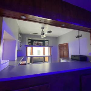 een keuken met blauwe verlichting in een kamer bij Glorious catering & Restaurant BnB in Ocker Hill