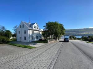 a white house on the side of a road at Akureyri Central House in Akureyri
