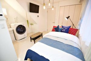 Postel nebo postele na pokoji v ubytování R-Guest Residence 東京浅草 east2