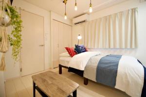 Postel nebo postele na pokoji v ubytování R-Guest Residence 東京浅草 east2
