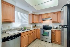 a kitchen with wooden cabinets and a stove top oven at 3 bedroom ground condo great views in Chandler