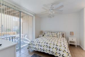 a white bedroom with a bed and a balcony at 3 bedroom ground condo great views in Chandler