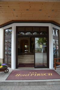 a entrance to a house with a sign on the door at Hotel Pirsch in Ramstein-Miesenbach