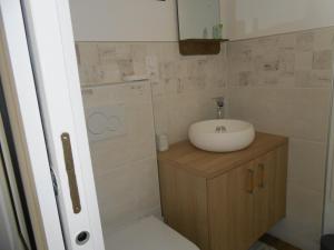 La petite salle de bains est pourvue d'un lavabo et de toilettes. dans l'établissement chambre hôte avec piscine - La Vialatte, à Gaillac