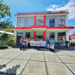 a group of people standing in front of a building at Omnea Hotel - Syariah in Bengkulu