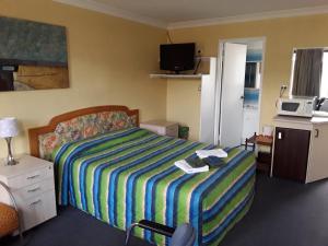Postel nebo postele na pokoji v ubytování Snowdream Motel