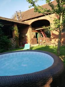 a large swimming pool in front of a house at Villa Holiday Home Kuća za odmor Slavonka in Kaptol