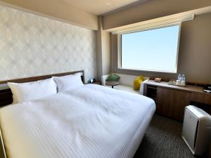 מיטה או מיטות בחדר ב-Wakoshi Tobu Hotel