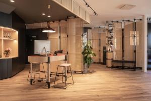 
a kitchen with a table and a refrigerator at Oru Hub Hotel in Tallinn

