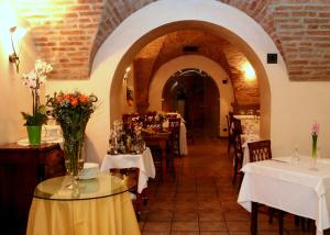 a restaurant with tables and chairs with flowers on them at Hotel Ristorante La Bettola in Urgnano