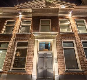 een bakstenen gebouw met een deur ervoor bij Bij Isa & Max in Kampen