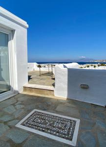 a patio with a couch and a view of the ocean at Maria Elena - Suite Home in Mýkonos City