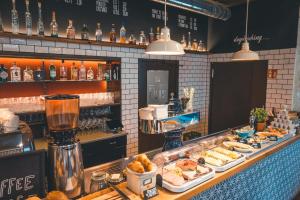 a buffet of food on a counter in a restaurant at Luis City Apartments Regensburg in Regensburg +66 photos