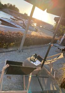 una silla y una sombrilla en una playa en Avanti Resort Mikołajki , w centrum przy jeziorze i promenadzie, śniadanie i obiad lub obiadokolacja w cenie en Mikołajki