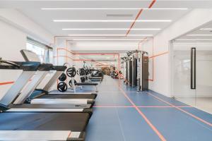 a gym with rows of treadmills and machines at Stey 798 Art Zone Hotel in Beijing