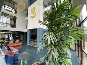 a palm tree in the middle of a lobby at HUNNU HOTEL in Ulan-Ude