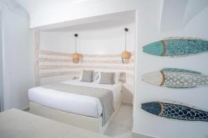 a white bedroom with two beds and pillows at Rhodos Horizon Blu-Adults Only in Rhodes Town