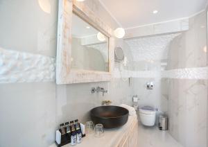 a bathroom with a sink and a mirror at Rhodos Horizon Blu-Adults Only in Rhodes Town