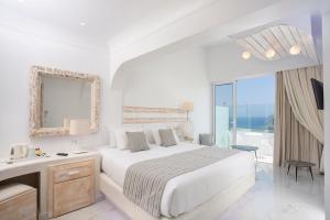 a white bedroom with a bed and a mirror at Rhodos Horizon Blu-Adults Only in Rhodes Town