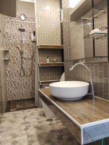 a bathroom with a sink and a shower at The Phura Villa Khaolak - SHA Extra Plus in Khao Lak