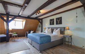 a bedroom with a bed in a room with wooden ceilings at Nice Apartment In Schwaan With Kitchen in Schwaan