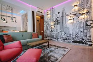 a living room with a couch and a mural of a city at No 6 Apartments in Constanţa
