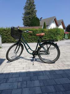 a bike with a basket parked on a sidewalk at Knusperhaus mit Garten in Salzburg