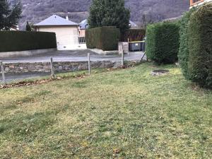 a yard with a house and a street with a fence at Tourmalet Home in Luz-Saint-Sauveur