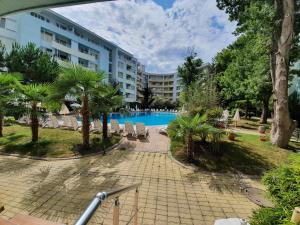 a resort with a swimming pool and a building at Yassen Holiday Village in Sunny Beach