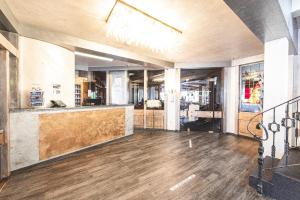 a lobby with a bar in a building at PLAZA Hotel Föhr am Bodensee in Friedrichshafen