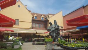 a statue in front of a building with flowers at Dolac Guesthouse in Zagreb