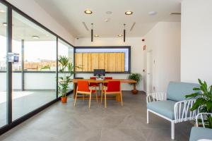 an office with a table and chairs and a computer at Hotel Taimar in Costa Calma