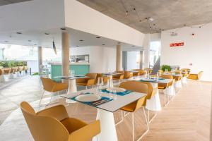 a dining room with tables and chairs in a building at Hotel Taimar in Costa Calma