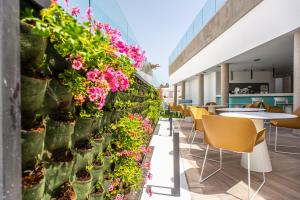 a restaurant with flowers on a wall at Hotel Taimar in Costa Calma