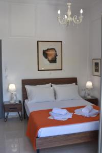 a bedroom with a bed with two towels on it at Porto Chania in Chania