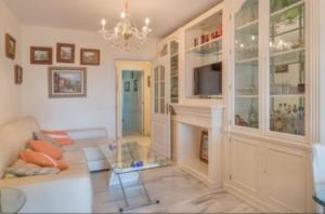 a living room with a couch and a fireplace at Mi Capricho in Sitio de Calahonda