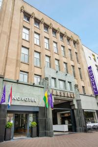 a large building with a sign on the side of it at Novotel Den Haag City Centre, fully renovated in The Hague