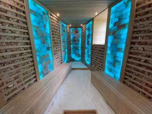 a room with wooden walls and blue lights at Bástya Konferencia és Wellness Hotel in Miskolctapolca +141 photos