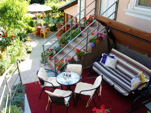 a balcony with a table and chairs and a staircase at "Pivnica i smestaj Jovanovic"- Rogljevacke pivnice in Rogljevo
