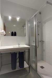 a bathroom with a sink and a shower at Apartamentos Arena Dorada in Puerto del Carmen