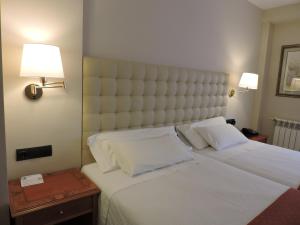 Postel nebo postele na pokoji v ubytování Hotel El Nogal