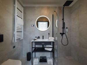 a bathroom with a sink and a shower with a mirror at Hotel Estera in Kraków