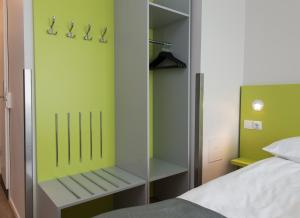
a bedroom with a bed and a dresser at Thon Hotel Trondheim in Trondheim
