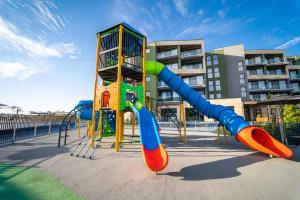 a playground with a slide in front of a building at HVD Reina del Mar - Premium Spa Service & Free Parking in Obzor